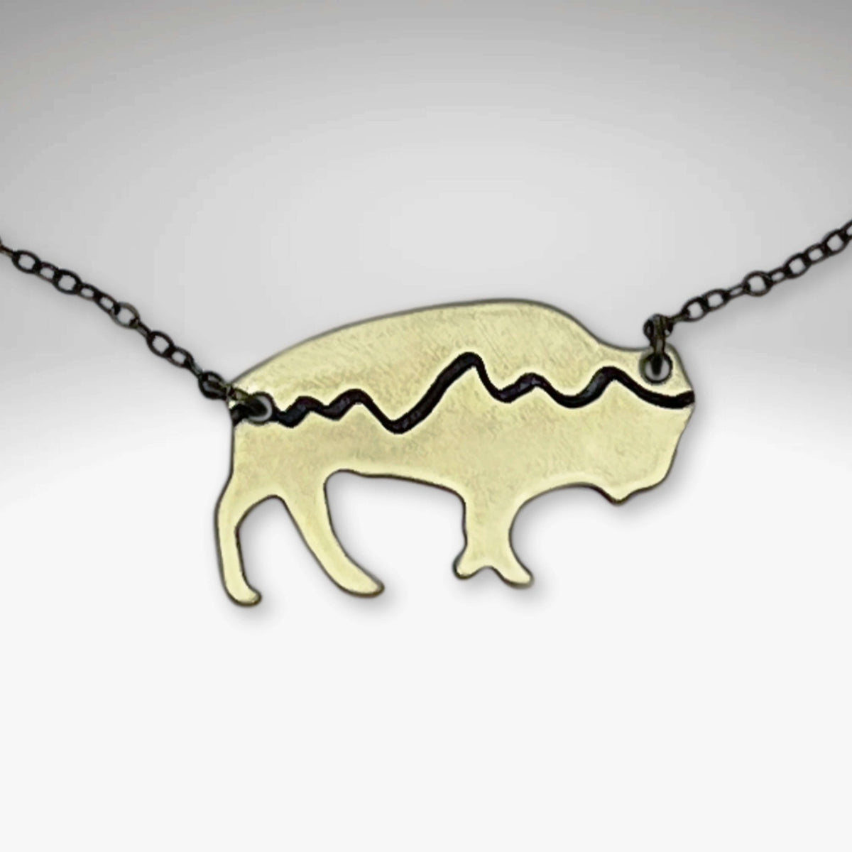 Mountains on Buffalo Necklace featuring a bison design with etched mountain silhouette on a rolo chain.