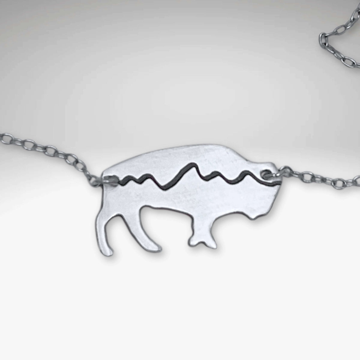 Mountains on Buffalo Necklace featuring a bison silhouette with Tetons design and rustic finish.