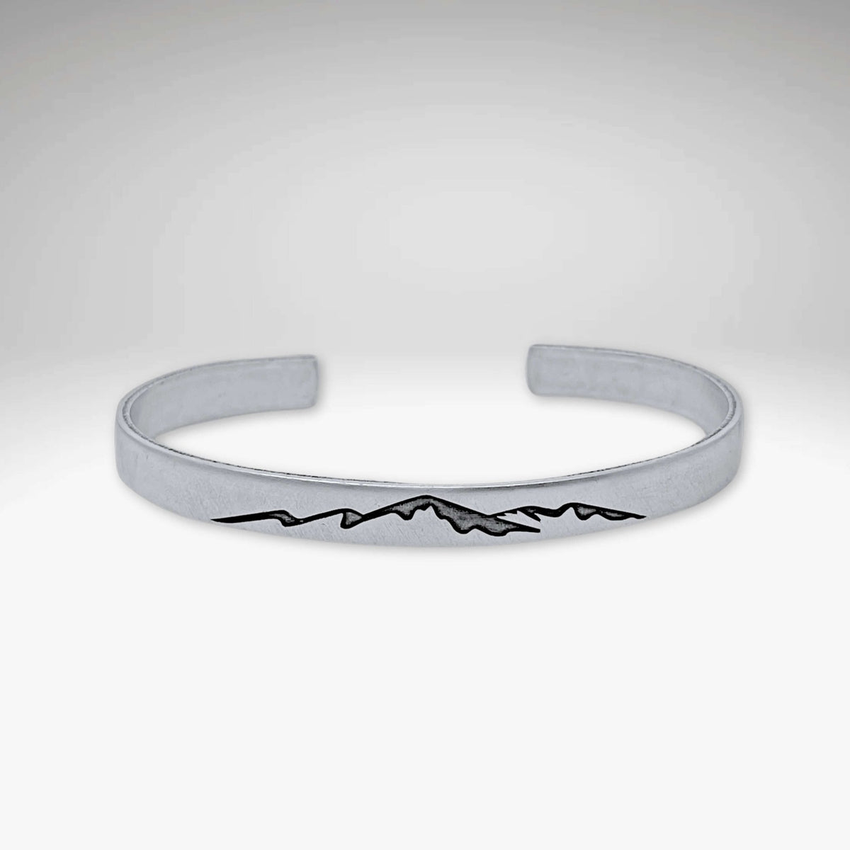 Mountainscape Mountain Cuff Bracelet in matte silver with mountain design etched on surface.