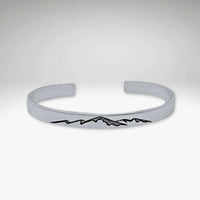 Mountainscape Mountain Cuff Bracelet in matte silver with mountain design etched on surface.