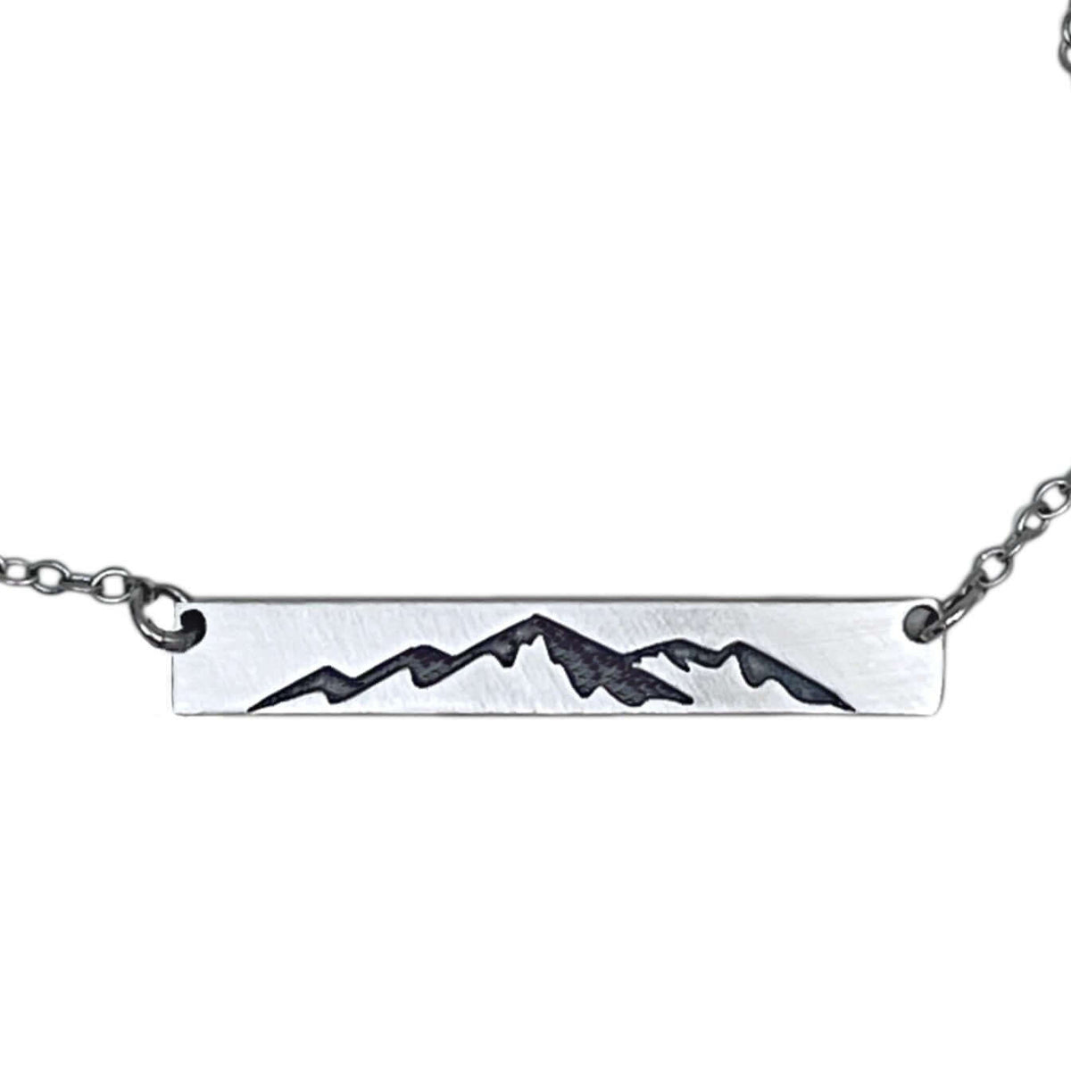 Mountainscape Necklace featuring a raw brass bar with mountain silhouette, adjustable cable chain, Matte Silver finish.