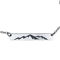Mountainscape Necklace featuring a raw brass bar with mountain silhouette, adjustable cable chain, Matte Silver finish.