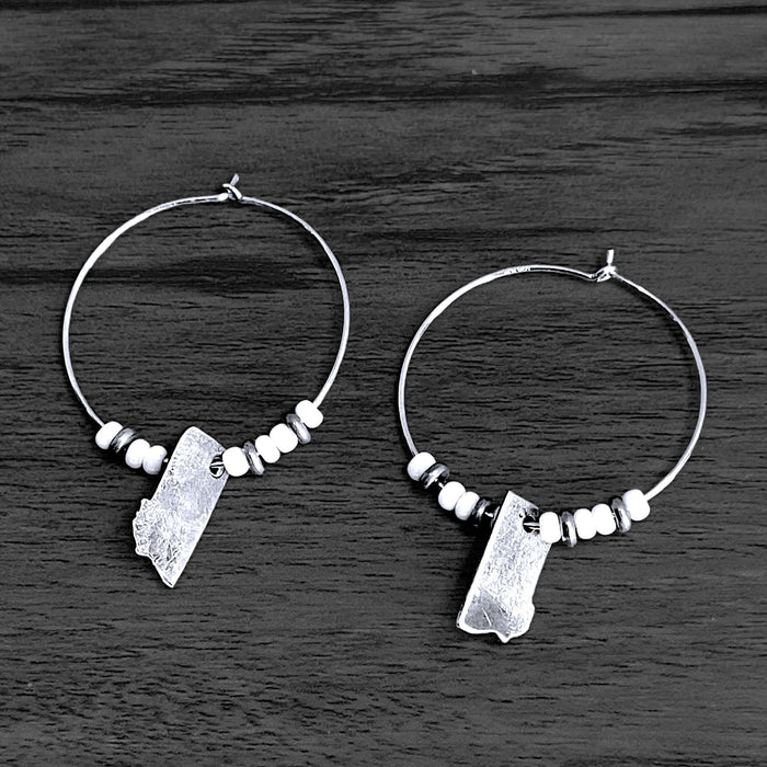MT Beaded Hoop Earrings with white seed beads and matte silver Montana cutouts.