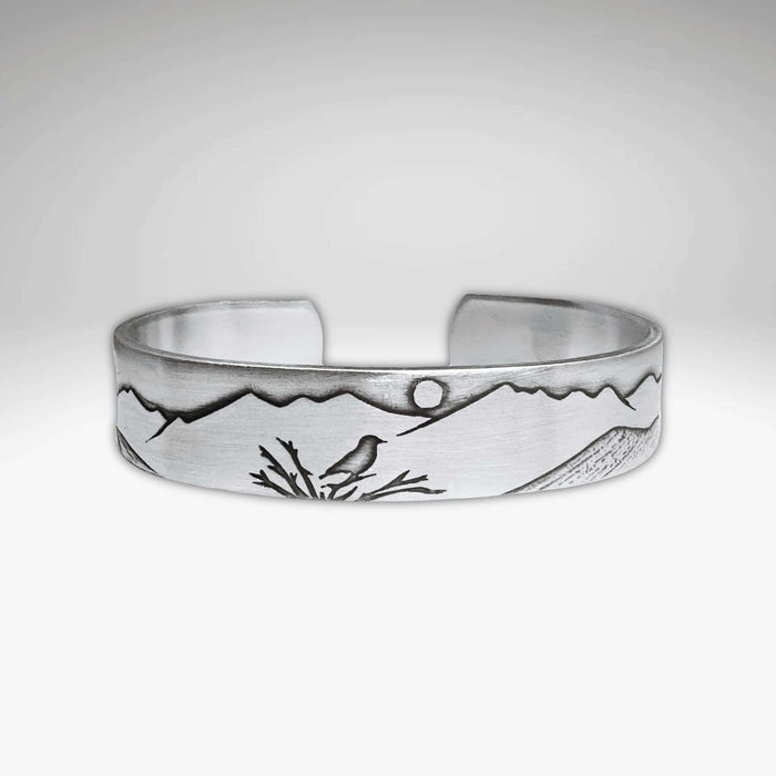 Mtn Bluebird Cuff Bracelet featuring an etched bluebird and mountain design on a raw brass cuff