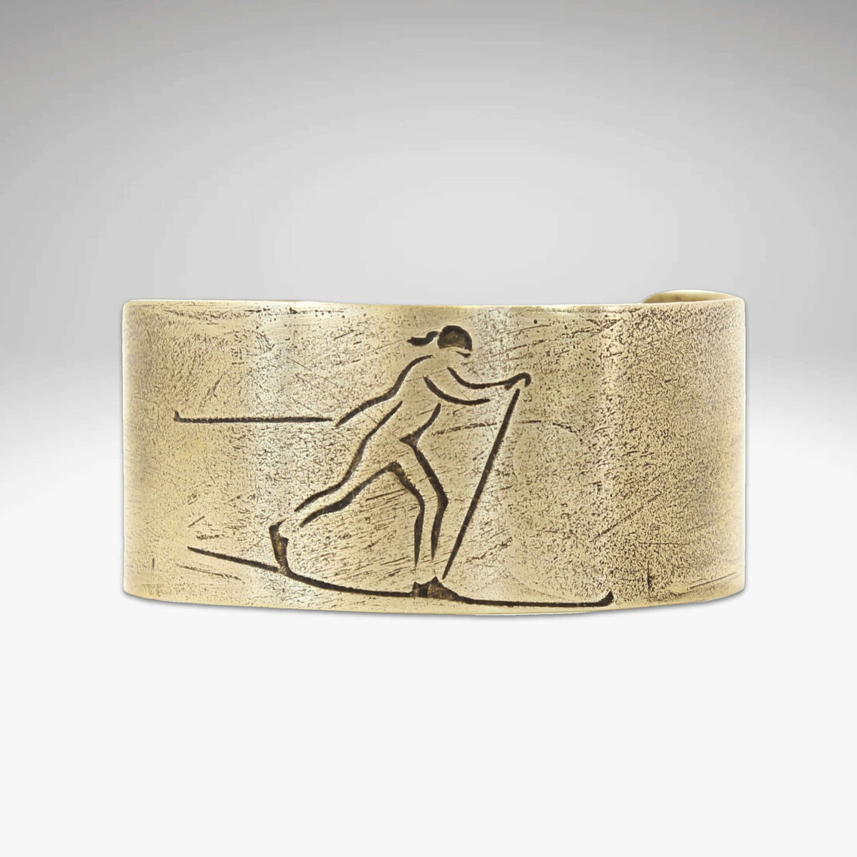 Nordic Run Cuff Bracelet featuring an etched Nordic skier design in a handmade cuff.