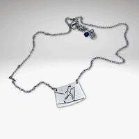 Nordic Run Necklace featuring a skier design on a silver chain, perfect for winter sports enthusiasts.