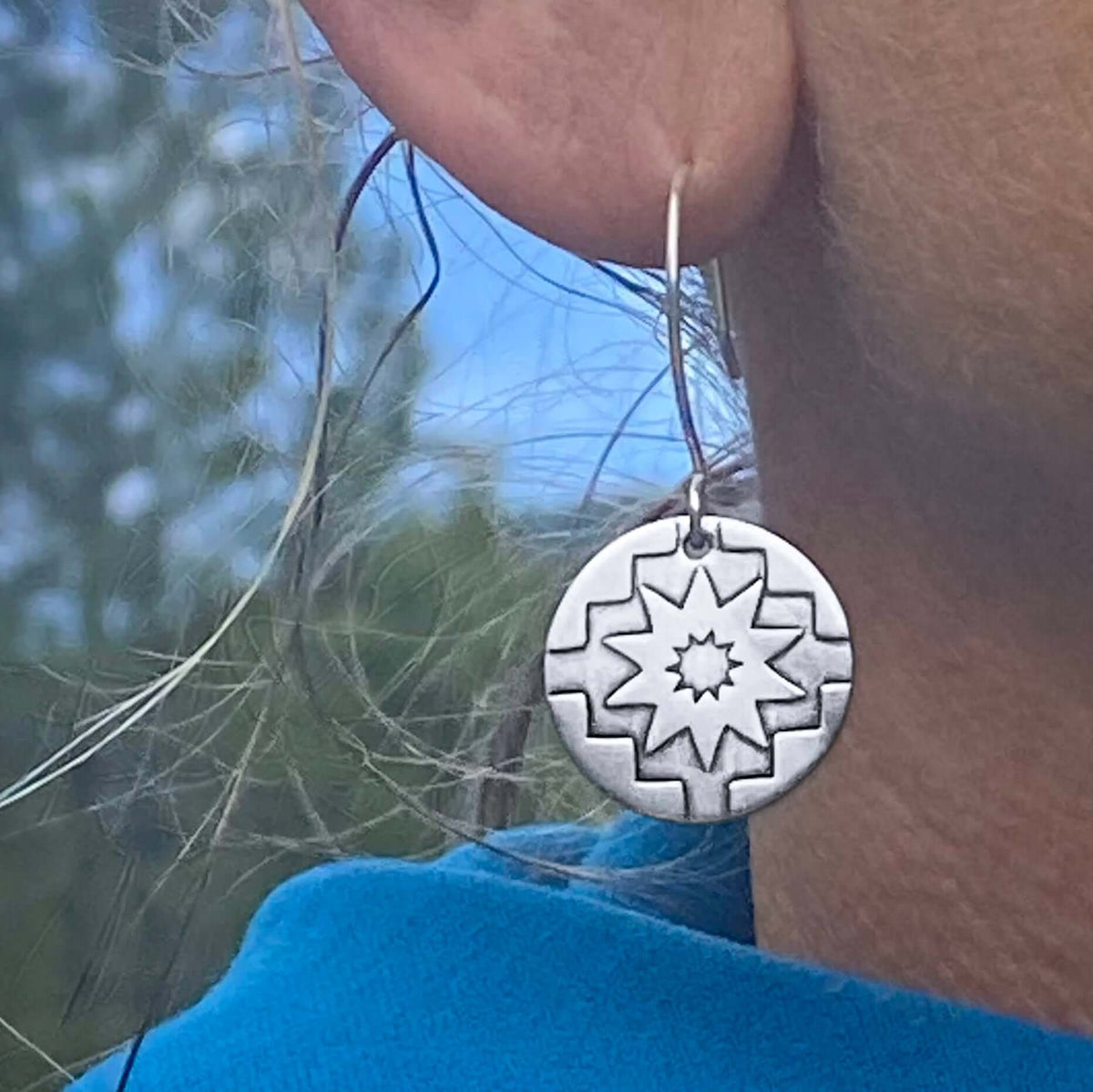 Northstar Earrings showcasing hand-etched design, symbolizing inspiration and guidance, crafted with sterling silver earwires.