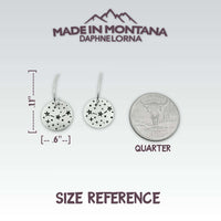 Orion's Belt Earrings size reference next to a quarter for scale, showcasing sleek celestial design.