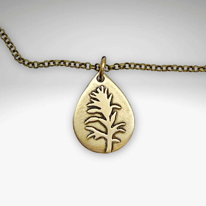 Gold teardrop pendant necklace featuring a paintbrush flower design - Paintbrush Necklace.