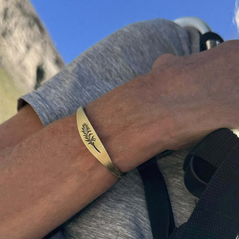 Paintbrush Signet Cuff worn on a wrist, featuring an elegant design in antique brass finish.