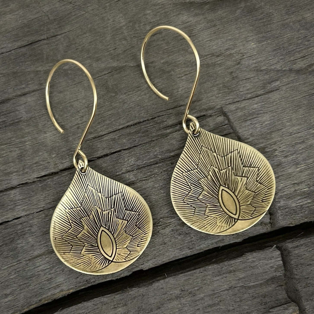 Petals Earrings in antique brass finish, showcasing delicate floral design on teardrop shape.