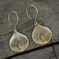 Petals Earrings in antique brass finish, showcasing delicate floral design on teardrop shape.