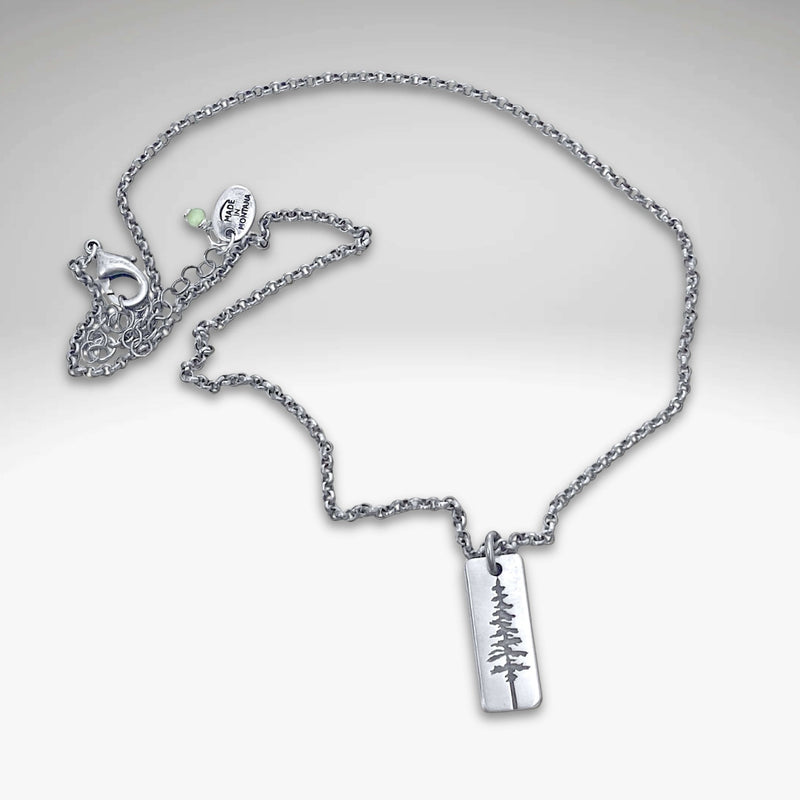 Pine Tree Necklace featuring a silver pendant with a Ponderosa Pine Tree design on a sleek chain.