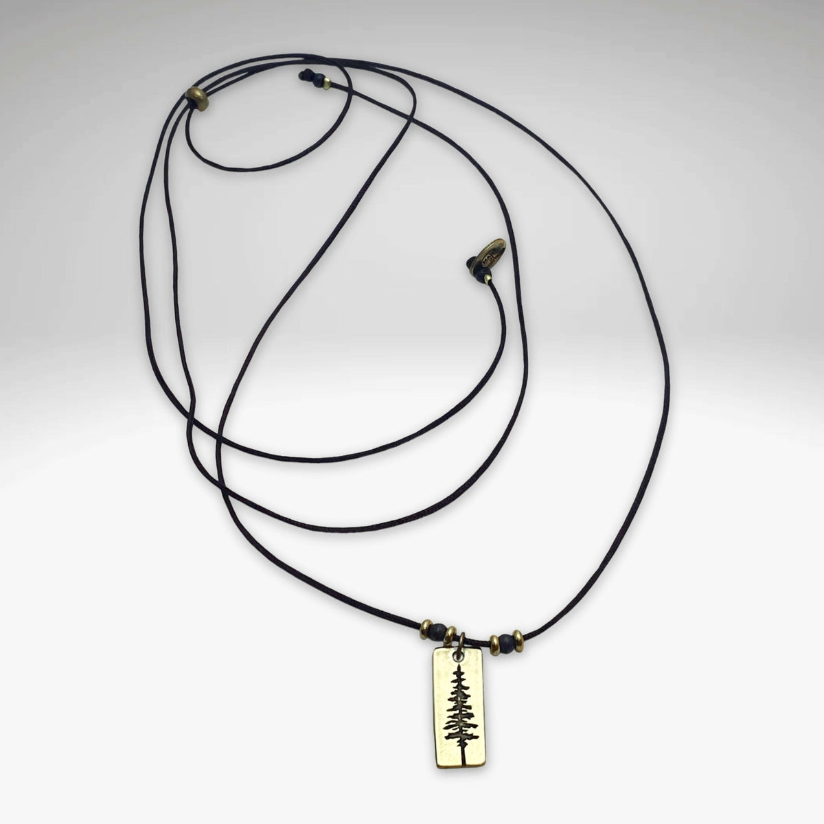 Pine Tree Necklace featuring a Ponderosa Pine pendant on a black cord, perfect for nature enthusiasts.