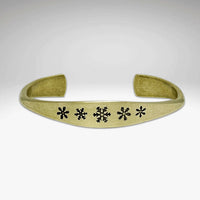 Powder Signet Cuff Bracelet with five snowflakes design, perfect for wintertime outdoor adventures.