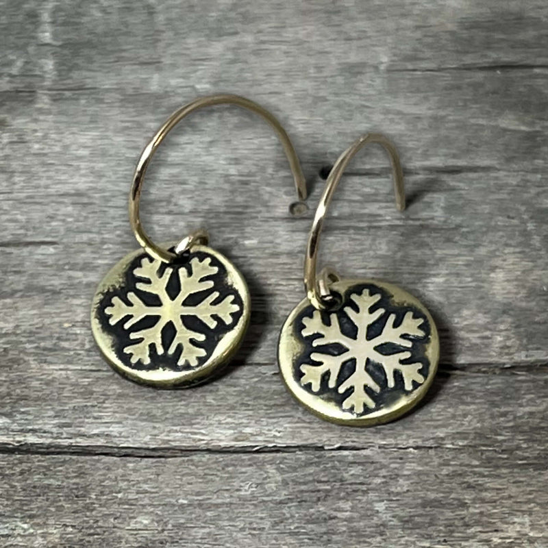 Powder Snowflake Earrings in antique brass with delicate etched snowflakes on 0.45" discs.