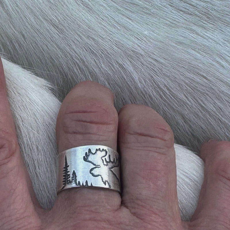 Creek Moose Adjustable Ring in matte silver  showcasing a moose silhouette against a forest backdrop.