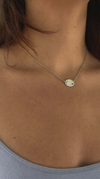 Woman wearing a Little Dipper Necklace featuring the Ursa Minor constellation in matte silver finish.