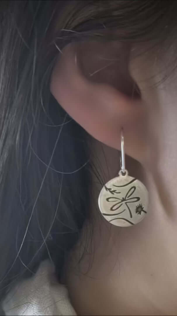 Video of a women wearing Dragonfly Earrings in matte silver finish with sterling silver earwires 