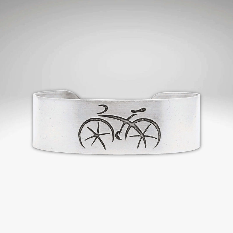 Ride Bicycle Cuff Bracelet featuring a simple bicycle design etched on raw brass.