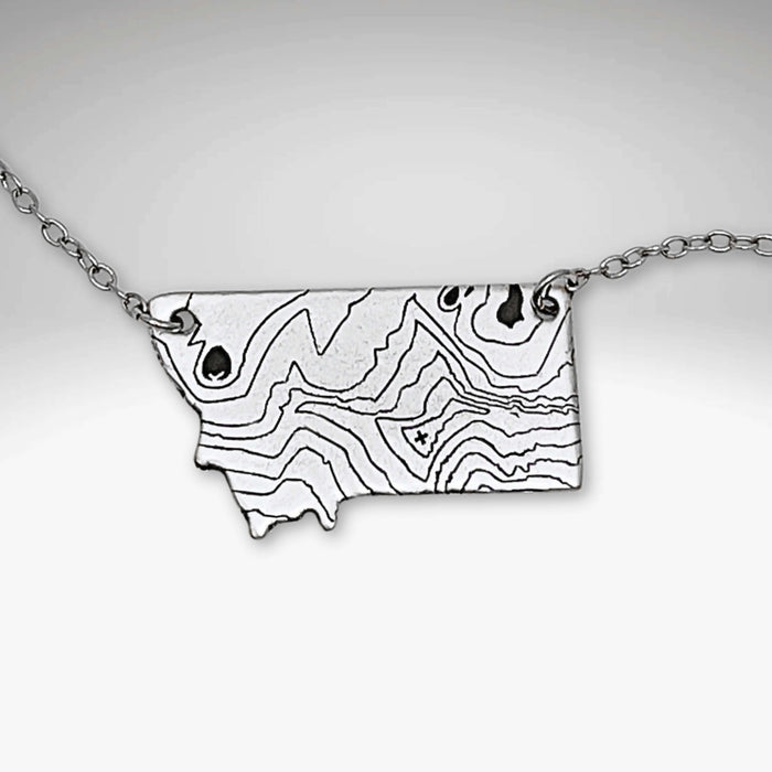Rising Wolf MT Necklace - Topo Montana featuring a topographic design of Montana mountains.