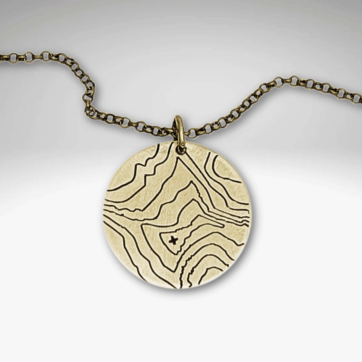 Rising Wolf Necklace featuring detailed topographic map design in Antique Brass finish, perfect for nature lovers.