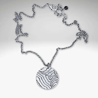 Rising Wolf Necklace featuring a detailed topographic map design in matte silver finish.