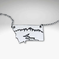 River Run Necklace showcasing a sleek Montana outline with mountains and a winding river design.