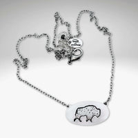Roam Free Necklace featuring a buffalo design on an oval pendant with a silver chain.