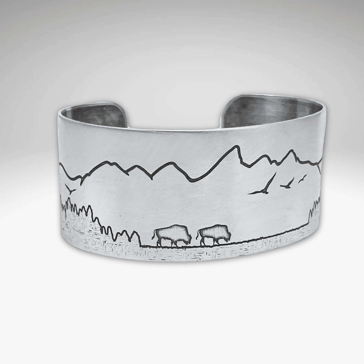 Roaming Buff on the Range Cuff Bracelet showcasing nature-inspired design with bison and mountain scenery.