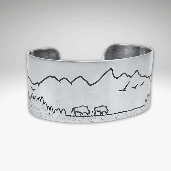Roaming Buff on the Range Cuff Bracelet showcasing nature-inspired design with bison and mountain scenery.