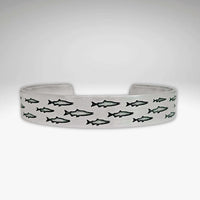 Salmon Run Cuff Bracelet featuring an intricate design of swimming salmon.
