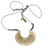 Scoop Necklace featuring a large geometric pendant on a delicate silk cord with hematite beads, adjustable from 16" to 18".