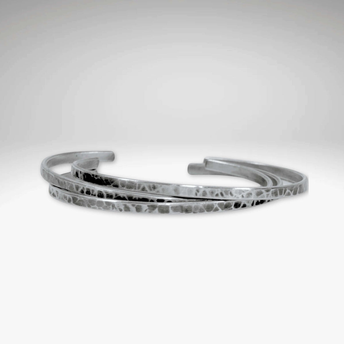 Set of Three Thin Cuff Bracelets in Matte Silver finish with a textured hammered design.
