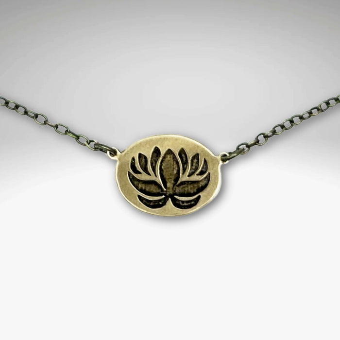 Simple Lotus Necklace featuring a beautifully etched lotus design on raw brass with a delicate chain.