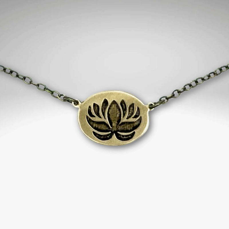 Simple Lotus Necklace featuring a beautifully etched lotus design on raw brass with a delicate chain.