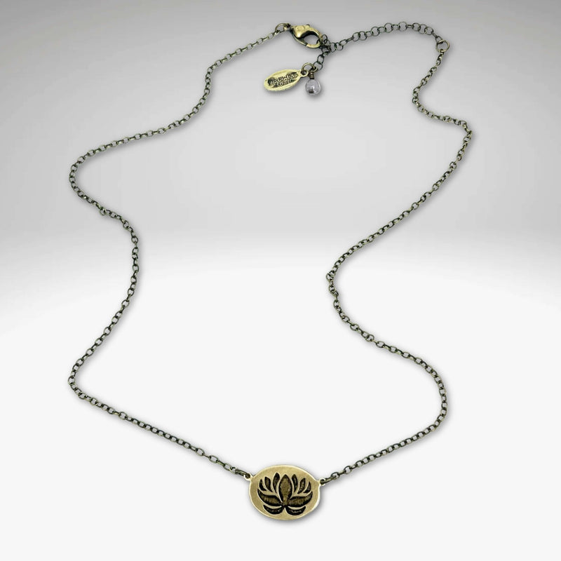 Simple Lotus Necklace featuring a small raw brass lotus pendant on a delicate chain.