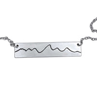 Simple Teton Mountain Necklace featuring a brass pendant with Teton mountain range outline.
