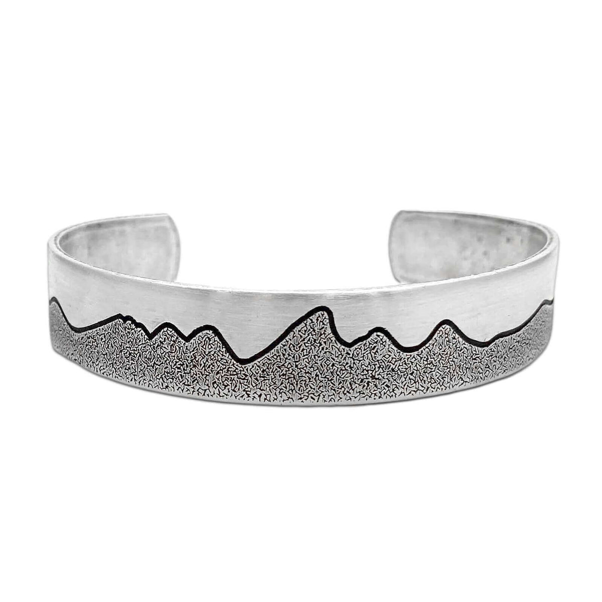Simple Tetons Cuff Bracelet showcasing mountain etching on a stylish silver cuff, perfect for nature lovers.