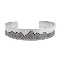 Simple Tetons Cuff Bracelet showcasing mountain etching on a stylish silver cuff, perfect for nature lovers.