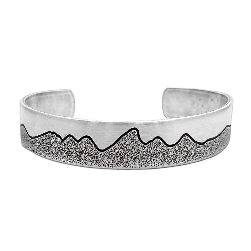 Simple Tetons Cuff Bracelet showcasing mountain etching on a stylish silver cuff, perfect for nature lovers.
