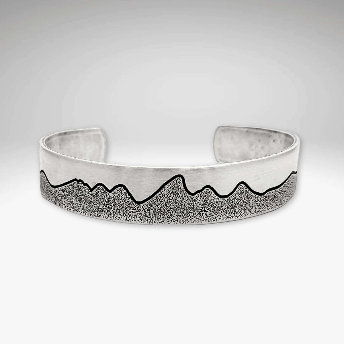 Simple Tetons Cuff Bracelet showcasing a unique mountain design and deep etching process, perfect accessory for nature lovers.
