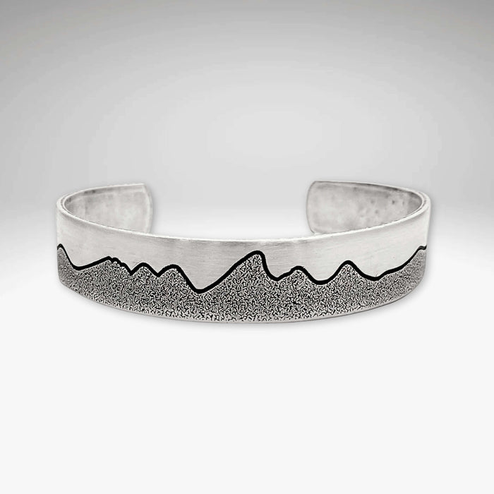 Simple Tetons Cuff Bracelet showcasing a unique mountain design and deep etching process, perfect accessory for nature lovers.