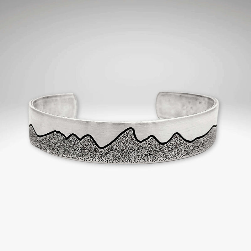 Simple Tetons Cuff Bracelet showcasing a unique mountain design and deep etching process, perfect accessory for nature lovers.