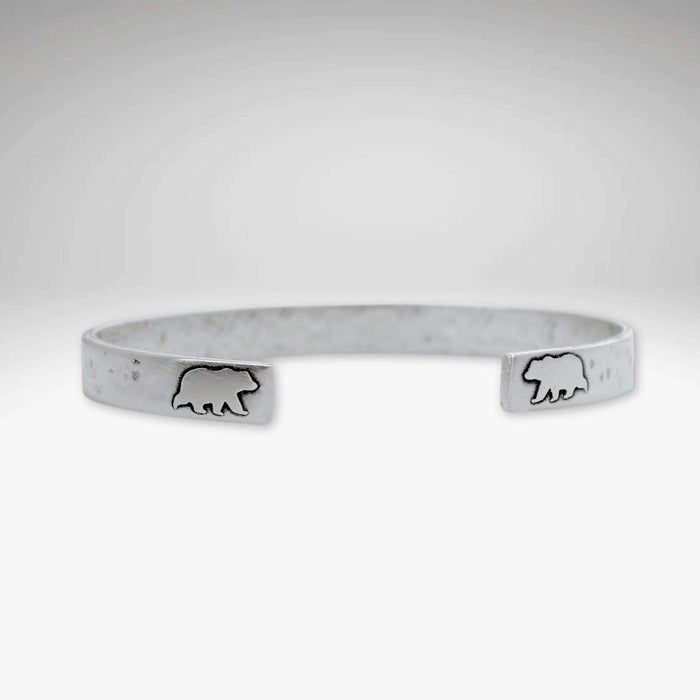 Skinny Bear Cuff Bracelet featuring bear engravings, 1/4" wide with a unique hammered texture.