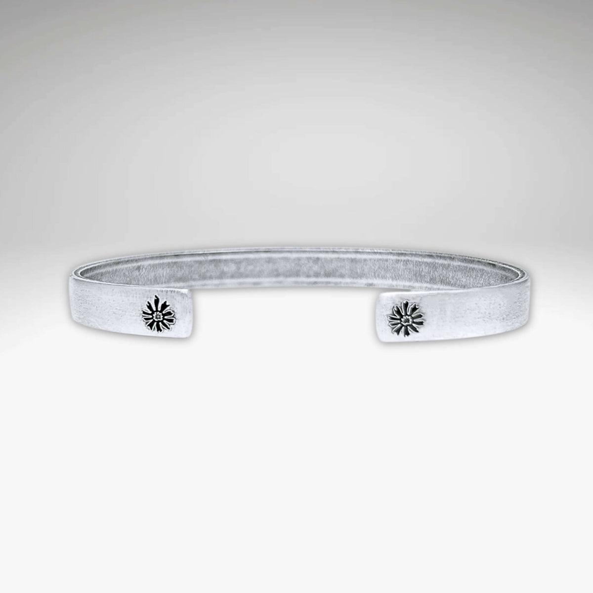 Skinny Bitterroot Flower Cuff Bracelet in matte silver with floral accents, adjustable and handmade in Montana.