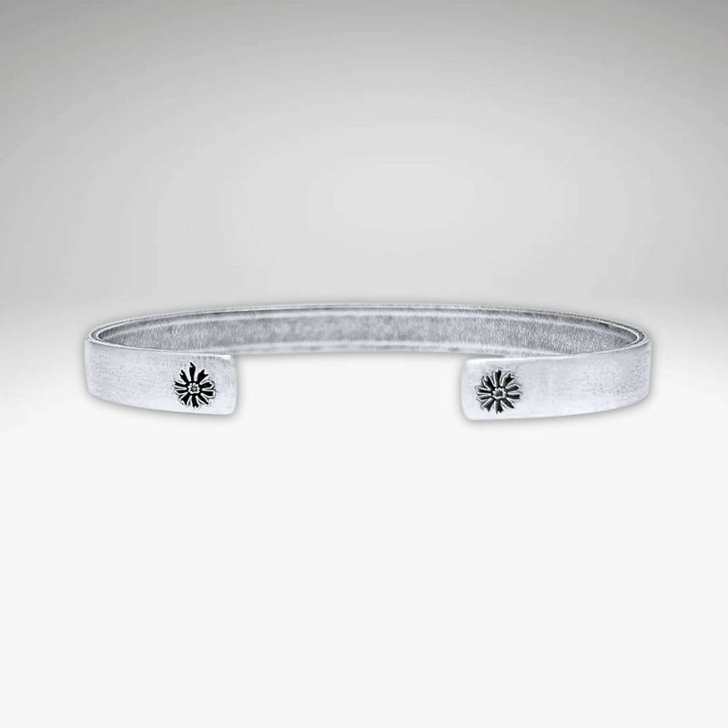 Skinny Bitterroot Flower Cuff Bracelet in matte silver with floral accents, adjustable and handmade in Montana.