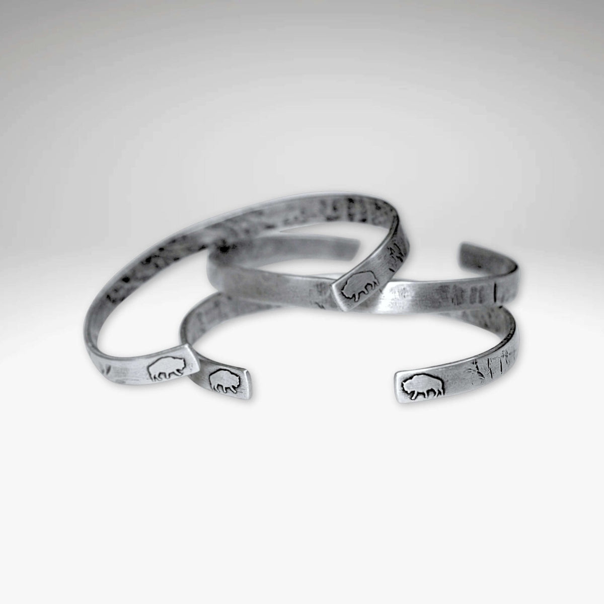 Skinny Buff Cuff Bracelet collection featuring unique bison designs and a sleek finish.