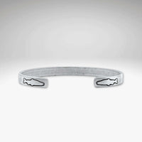 Skinny Fish Cuff Bracelet with etched fish design on tips, showcasing raw brass texture and stylish appeal.