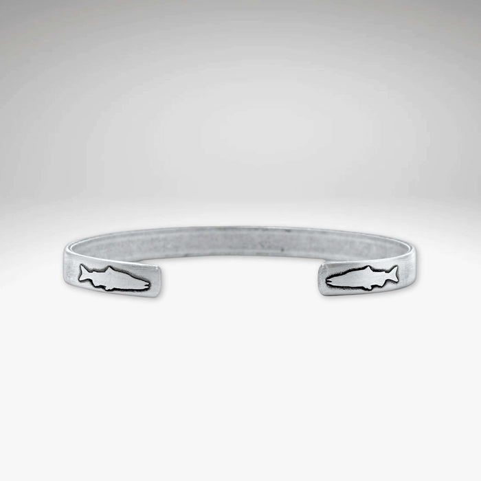 Skinny Fish Cuff Bracelet with etched fish design on tips, showcasing raw brass texture and stylish appeal.